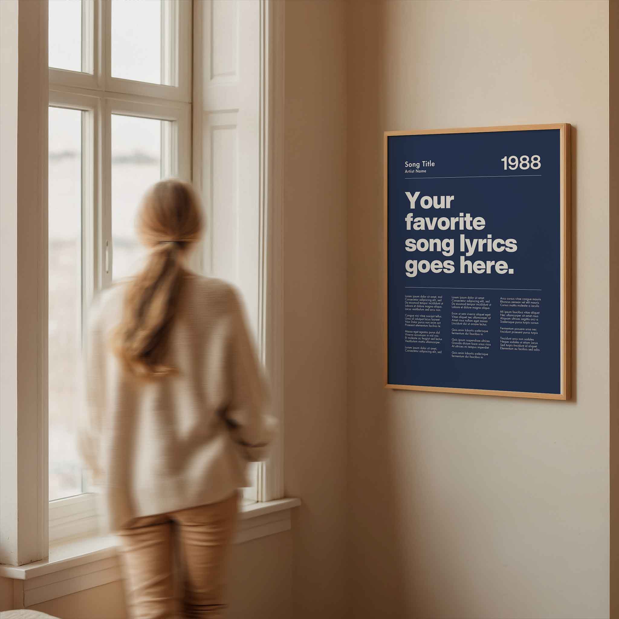 a woman looking out a window at a poster