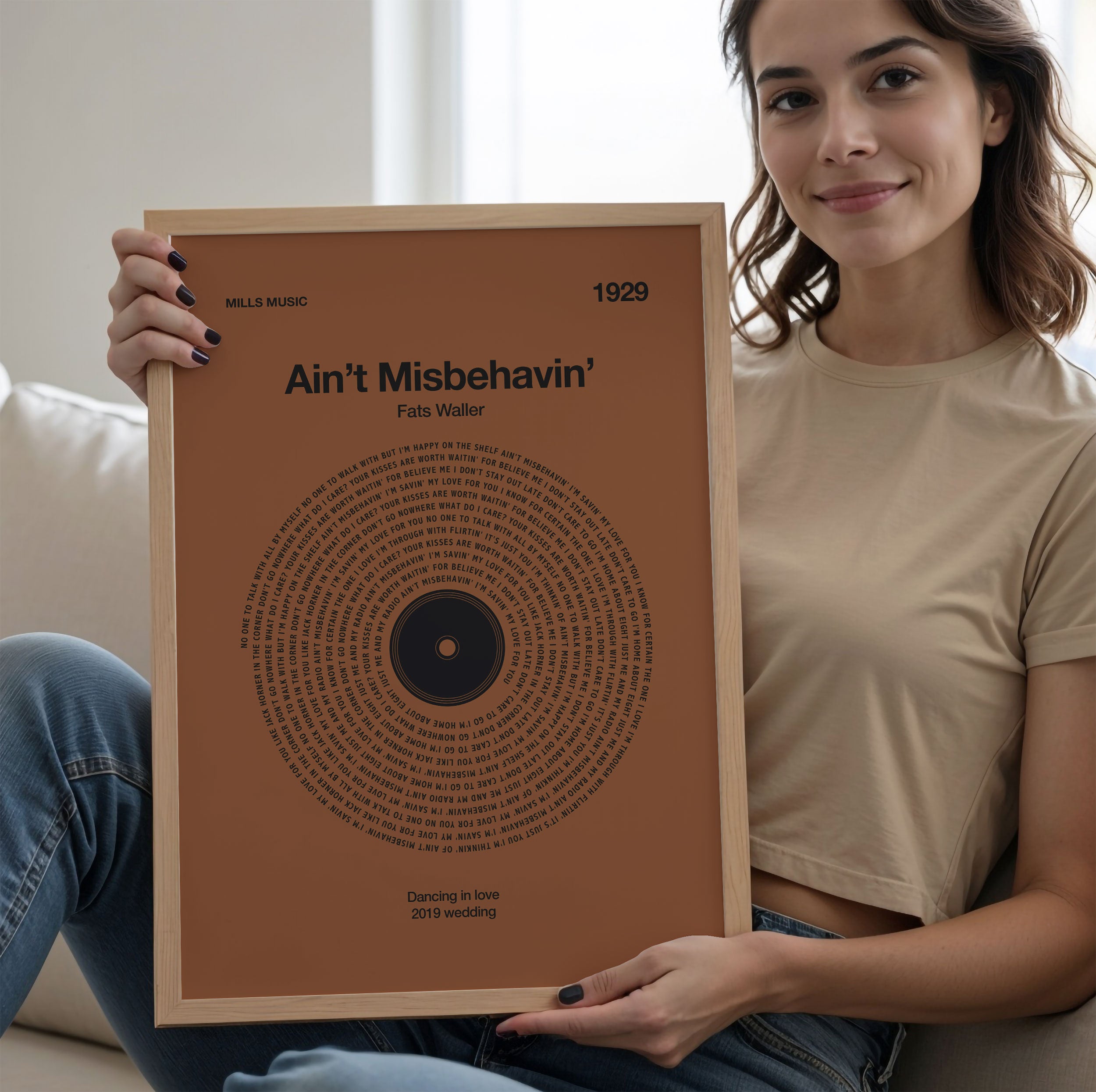 Rich Rust-colored background personalized song lyrics print in a vinyl record style, rustic music gift. Woman holding a framed record cover with text and a circular design.