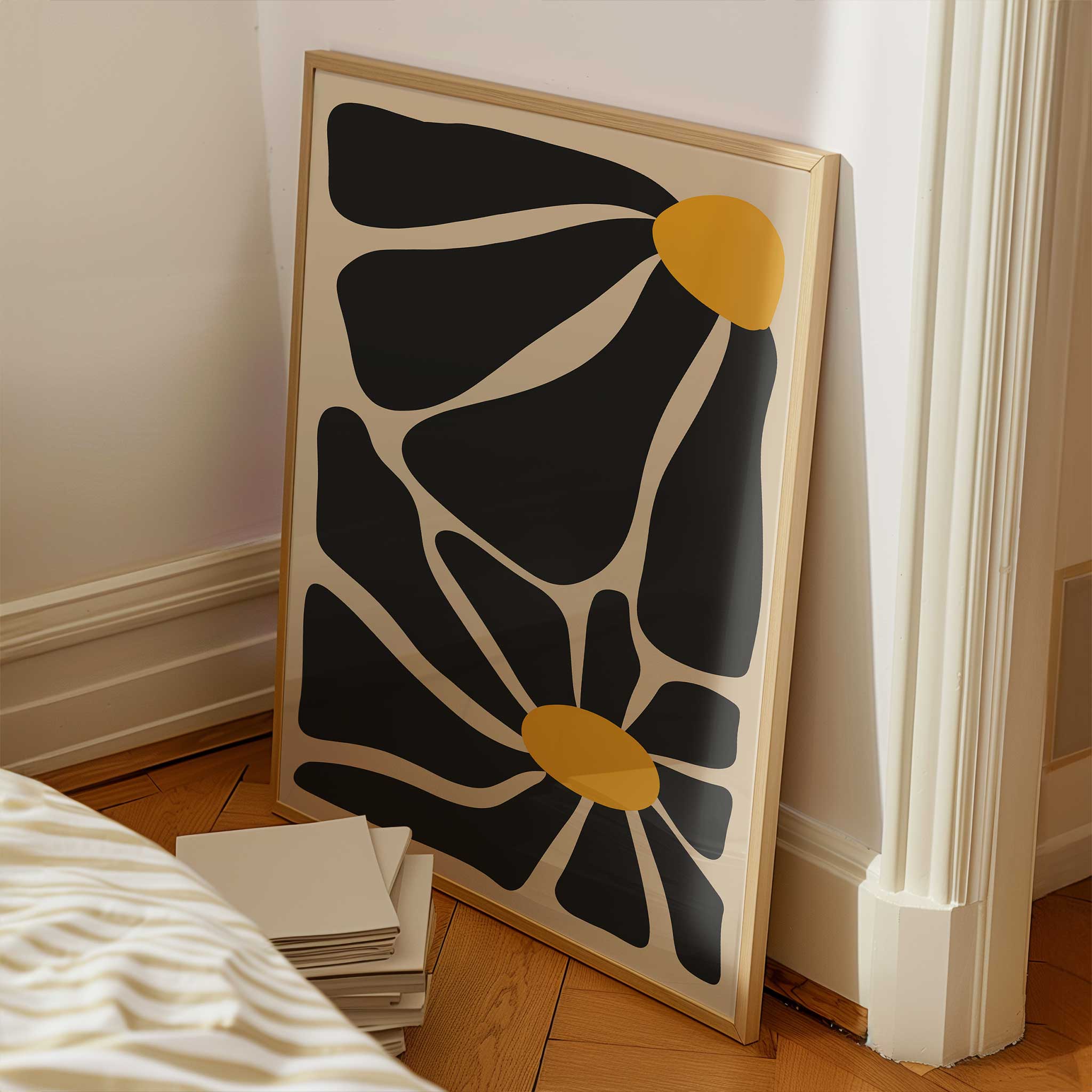 A bold, contemporary abstract print of two flowers with oversized black petals and vivid golden centers.