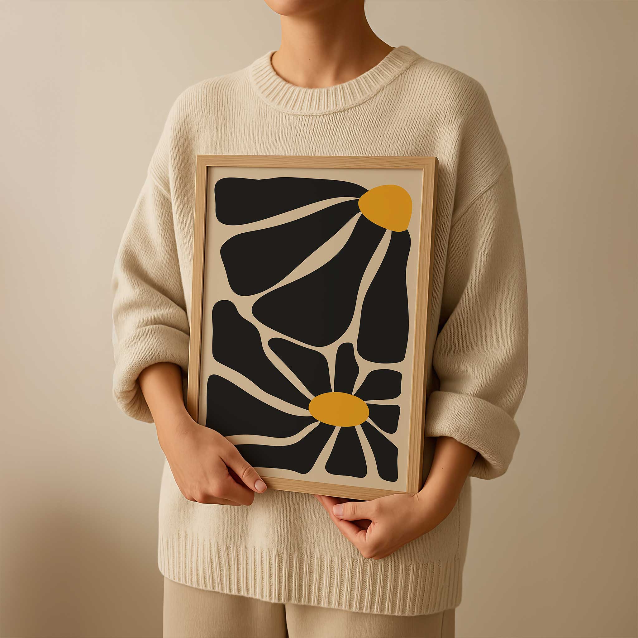 A bold, contemporary abstract print of two flowers with oversized black petals and vivid golden centers.