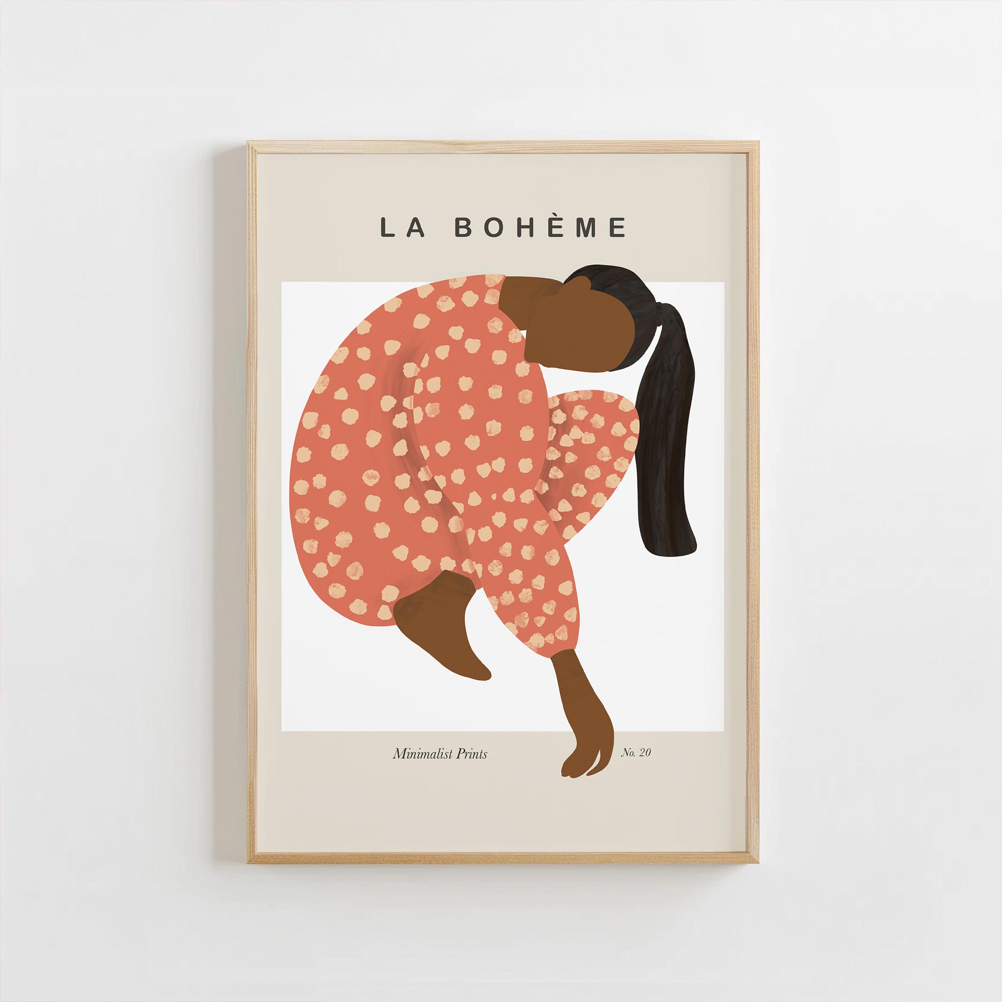 Framed artwork of a woman in a polka dot dress with 'La Bohème' text on a beige background
