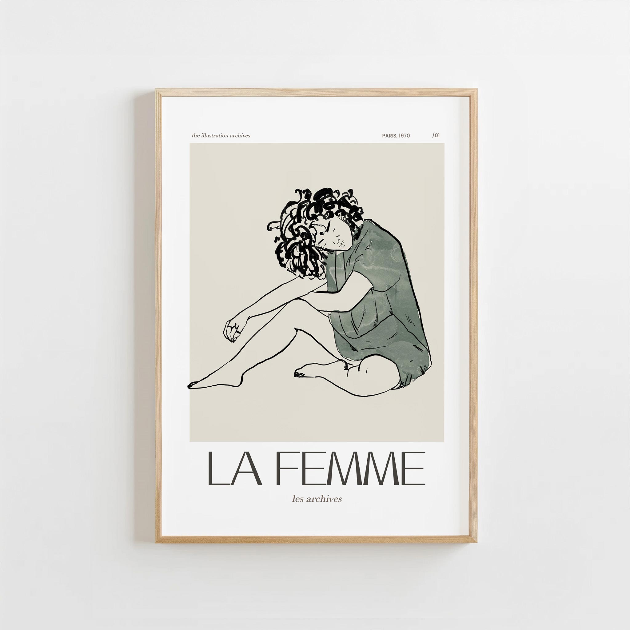 Framed artwork of a woman sitting with text 'LA FEMME' on a white background
