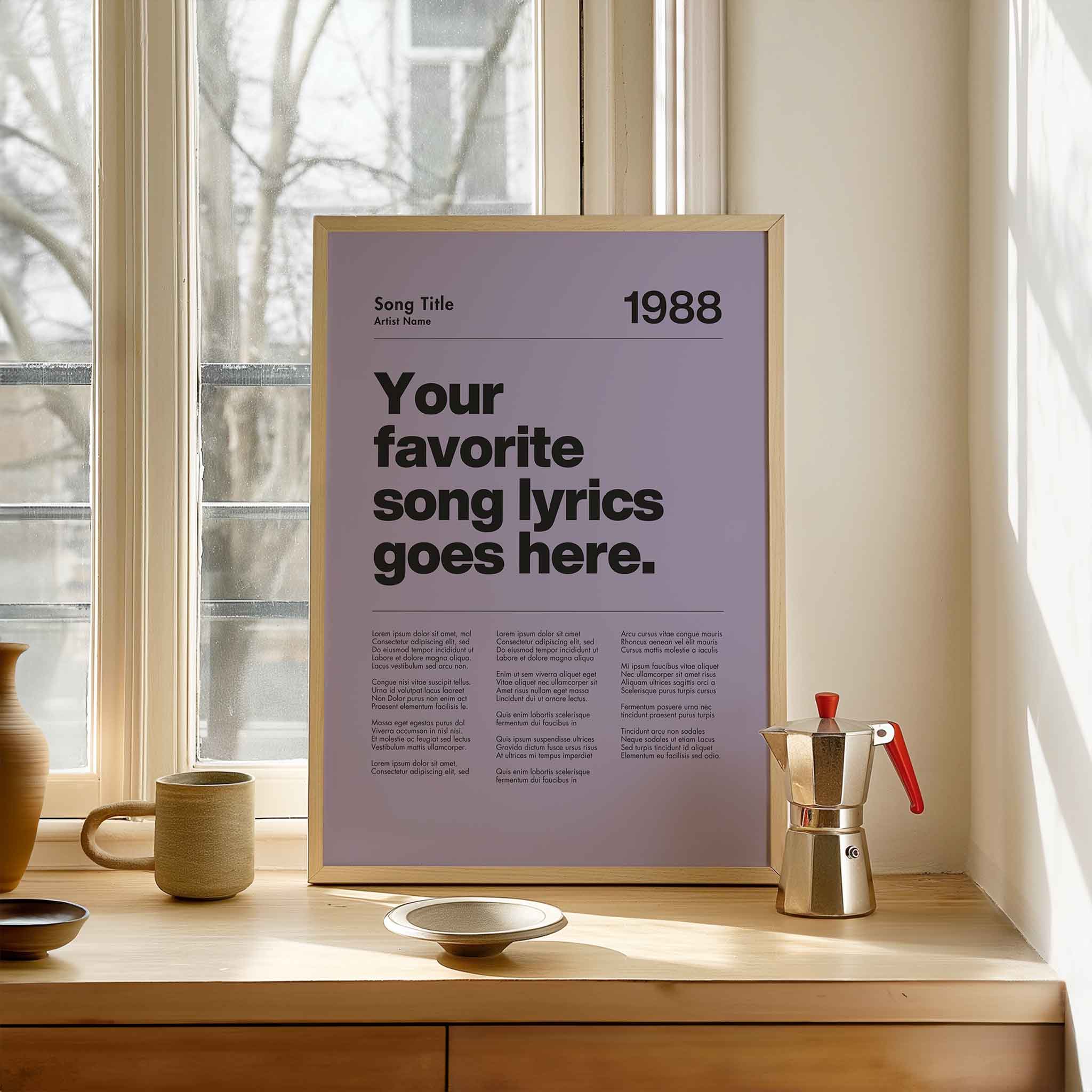 a poster sitting on a window sill next to a cup and saucer