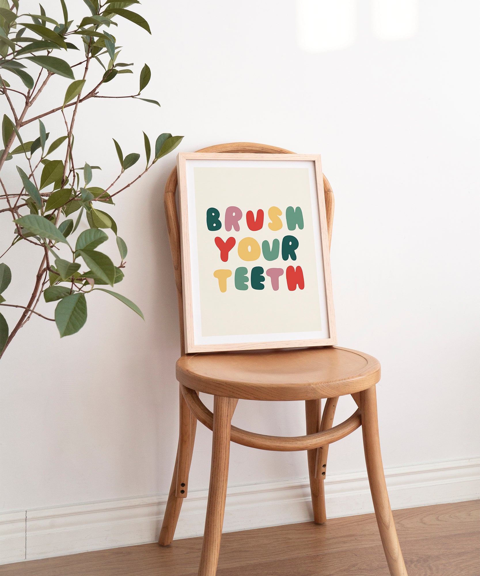 Brush Your Teeth' humorous typography print, fun framed wall art for a modern bathroom aesthetic.