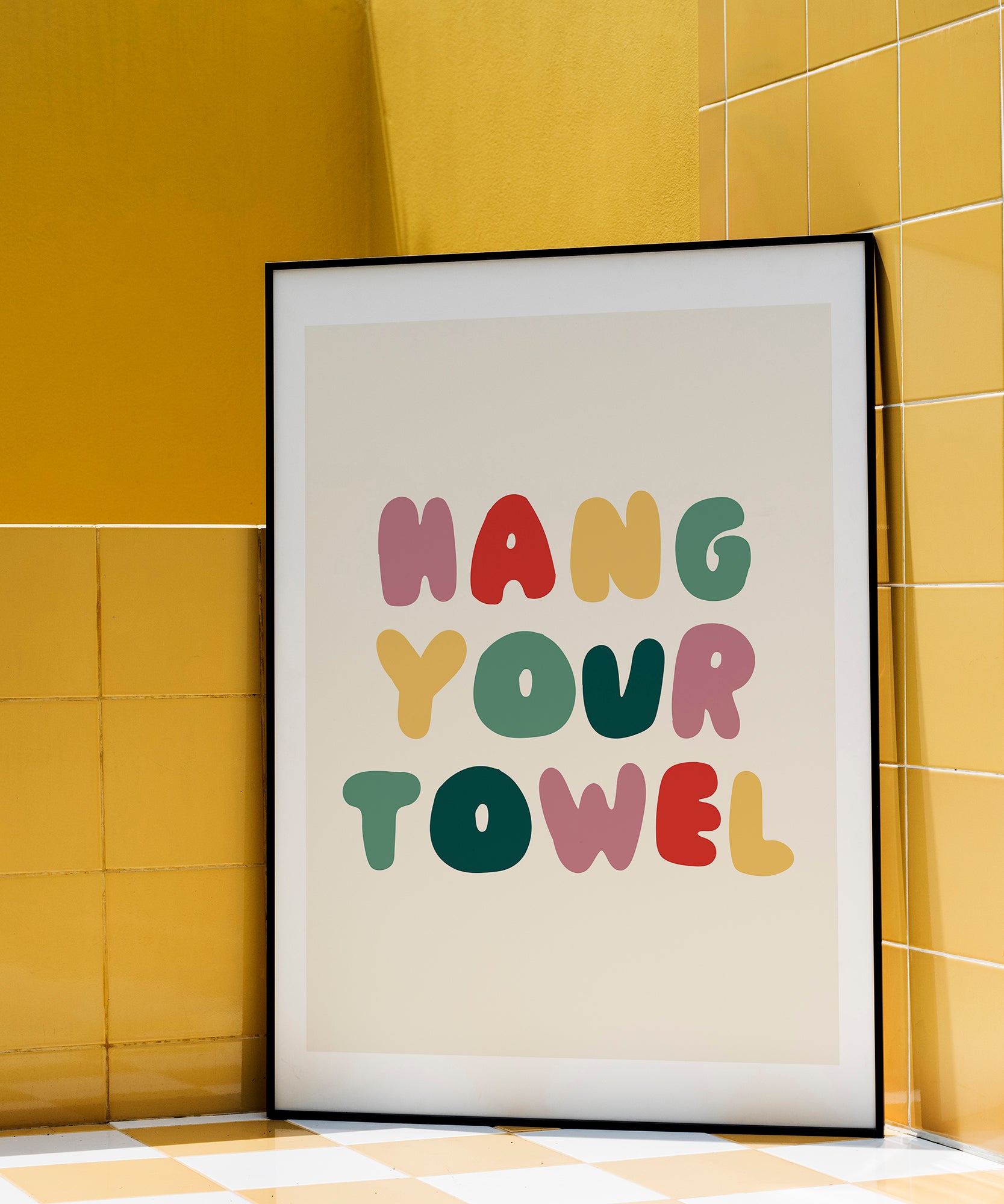Hang Your Towel' playful typography, framed wall art prints for a humorous bathroom aesthetic.
