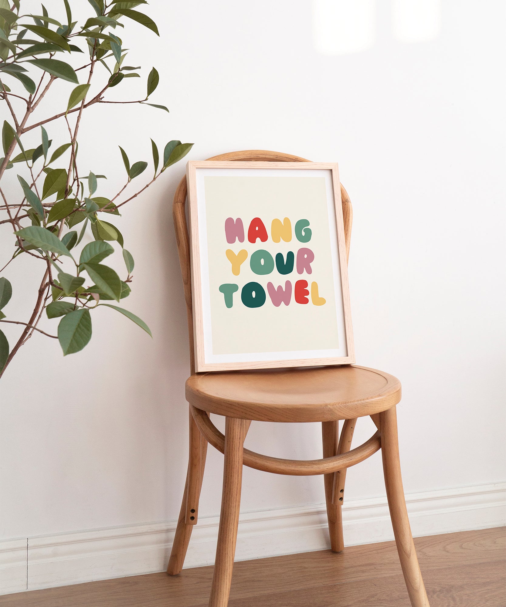 Hang Your Towel' playful typography, framed wall art prints for a humorous bathroom aesthetic.