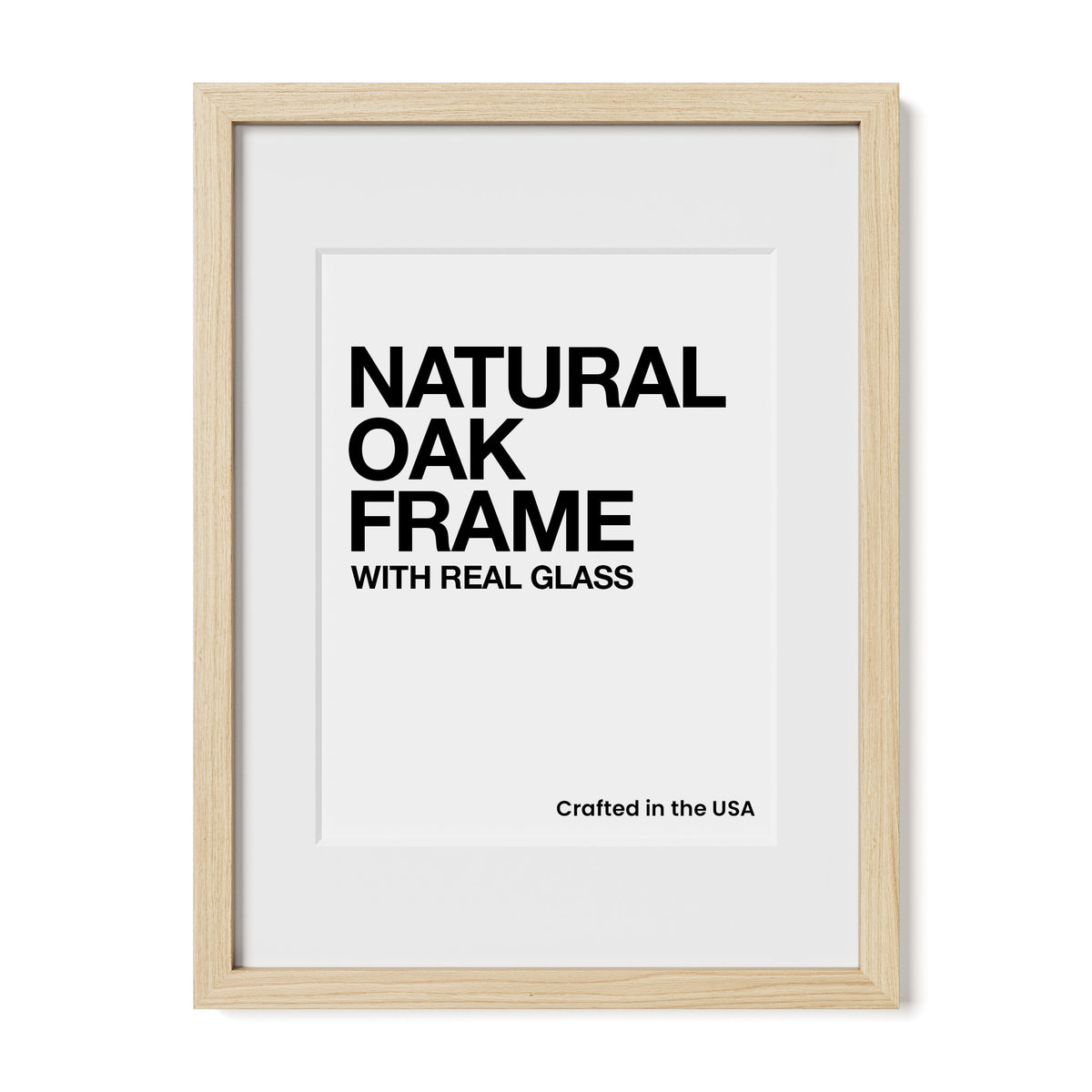 a framed print with the text "NATURAL OAK FRAME WITH REAL GLASS" and "Crafted in the USA" printed on it.