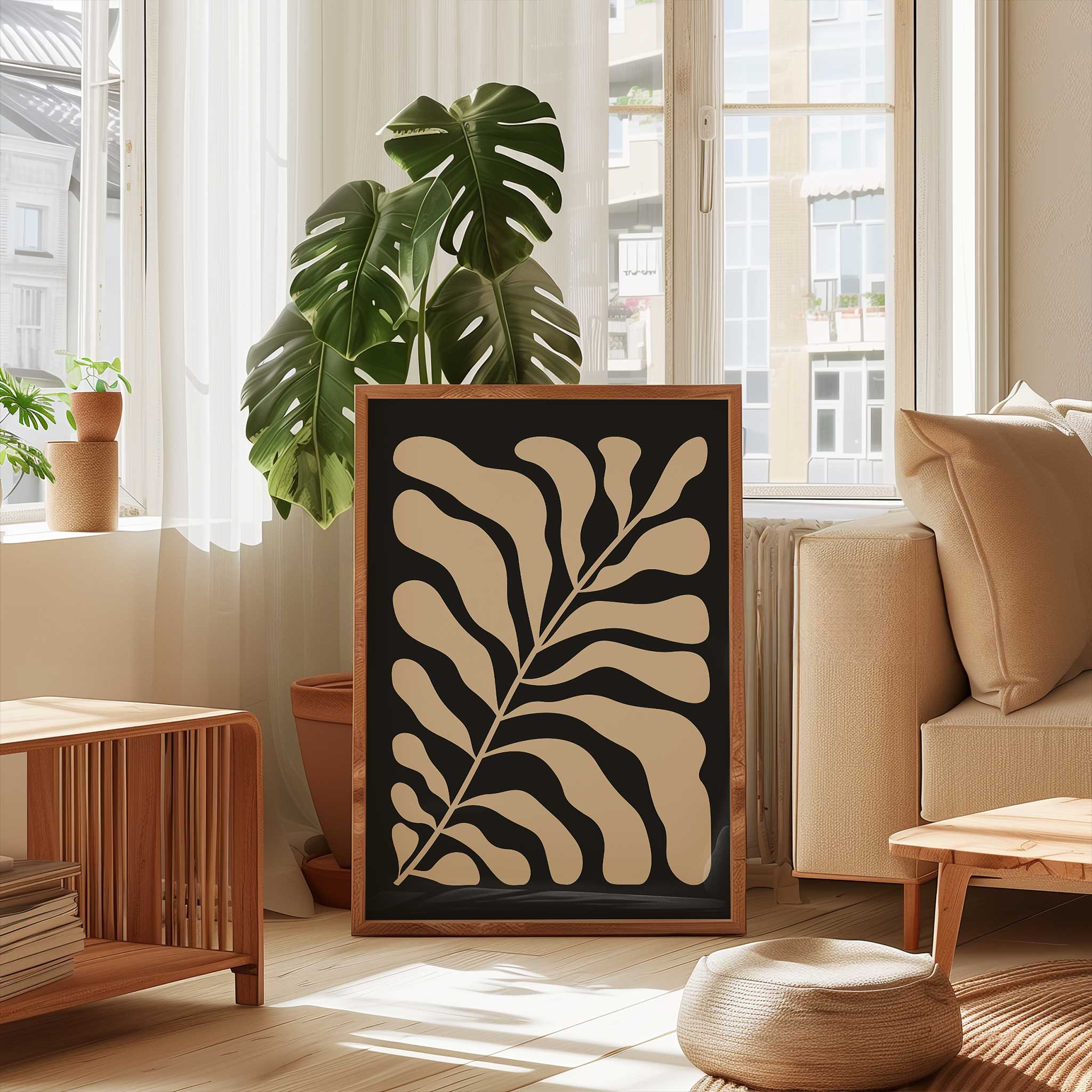 A minimalist print of flowing beige botanical leaves against a solid black background.