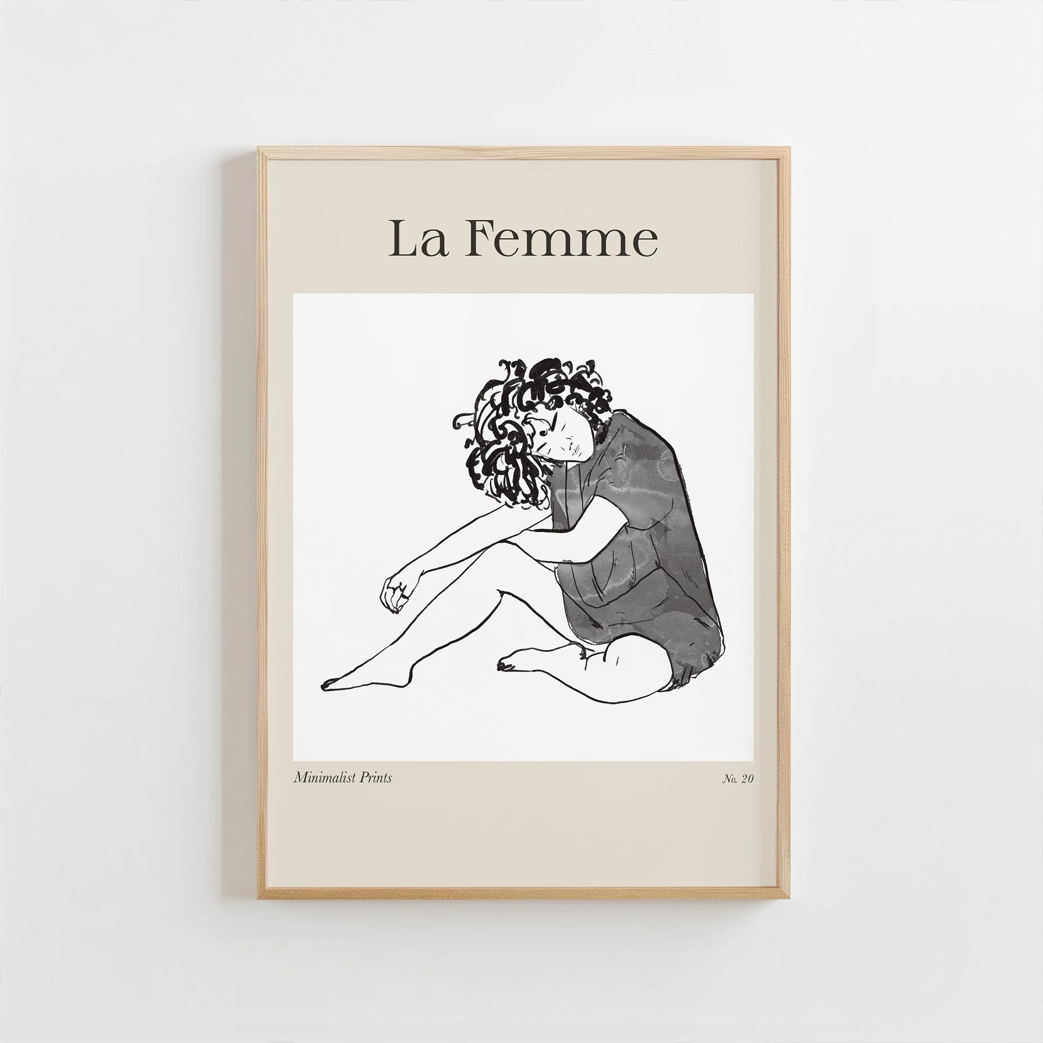 Framed artwork titled 'La Femme' with a black and white illustration of a woman on a beige background.