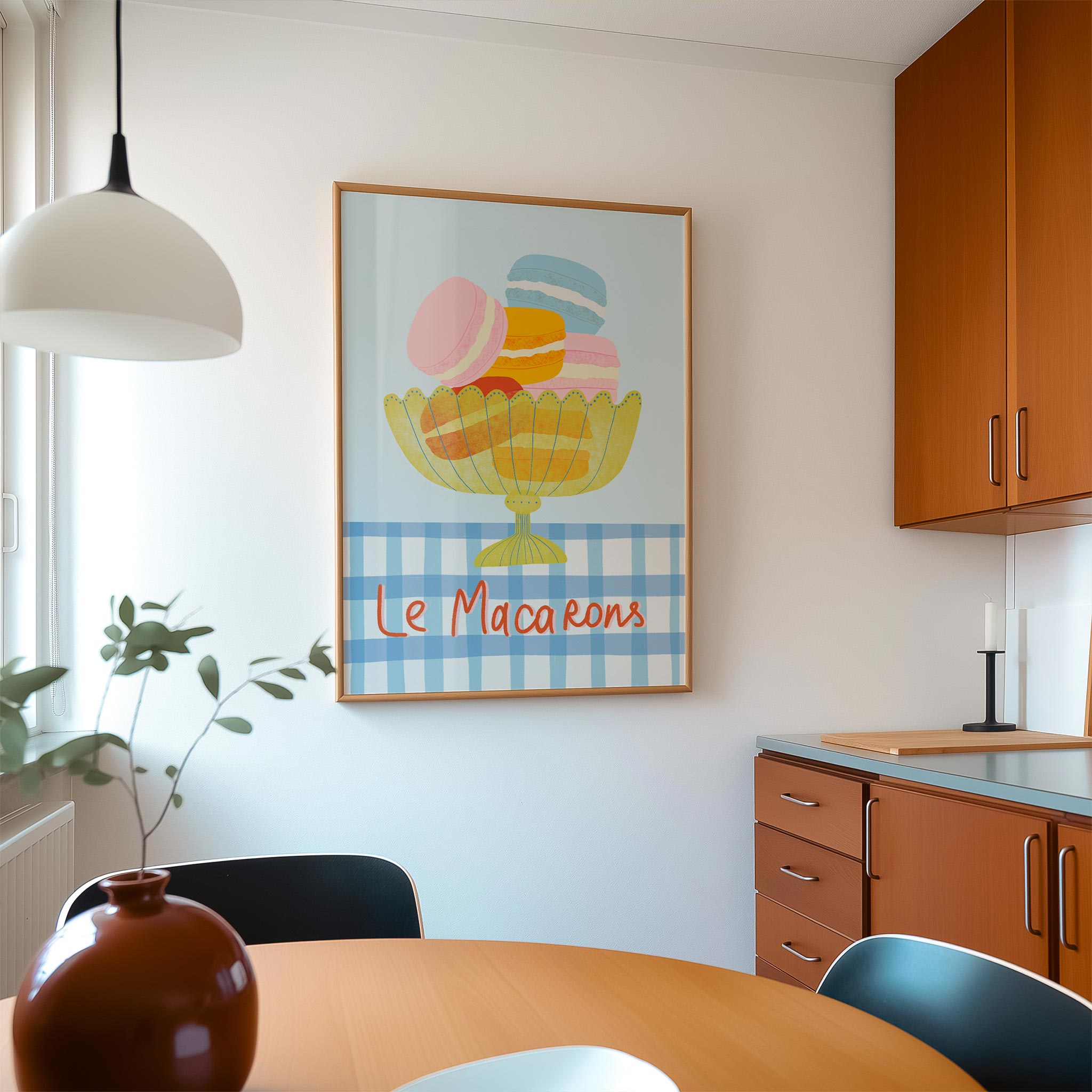 Kitchen interior with a colorful 'Le Macarons' artwork on the wall.