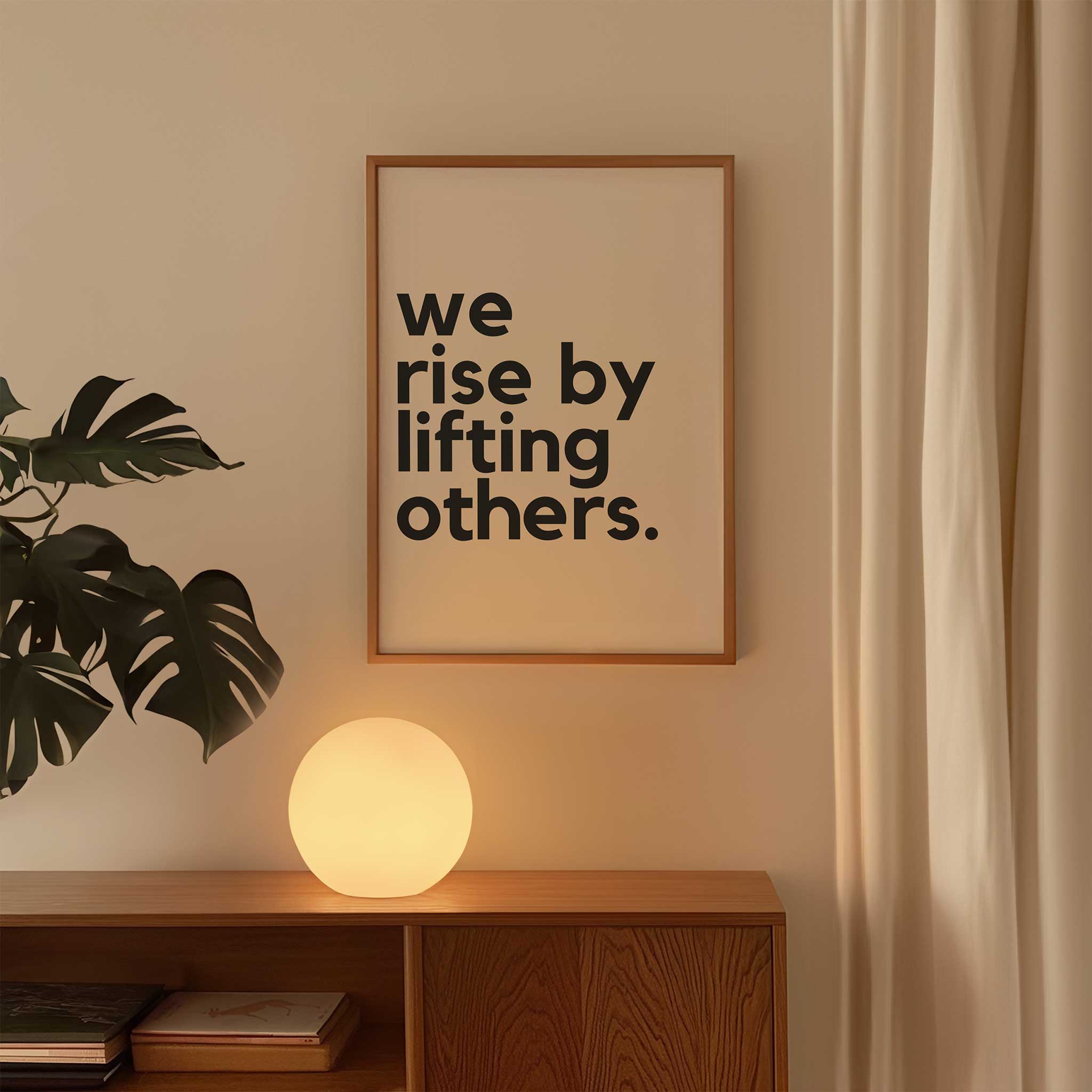 We Rise by Lifting Others' empowering typography, framed wall art print for a kindness aesthetic, titled 'We Rise by Lifting Others'