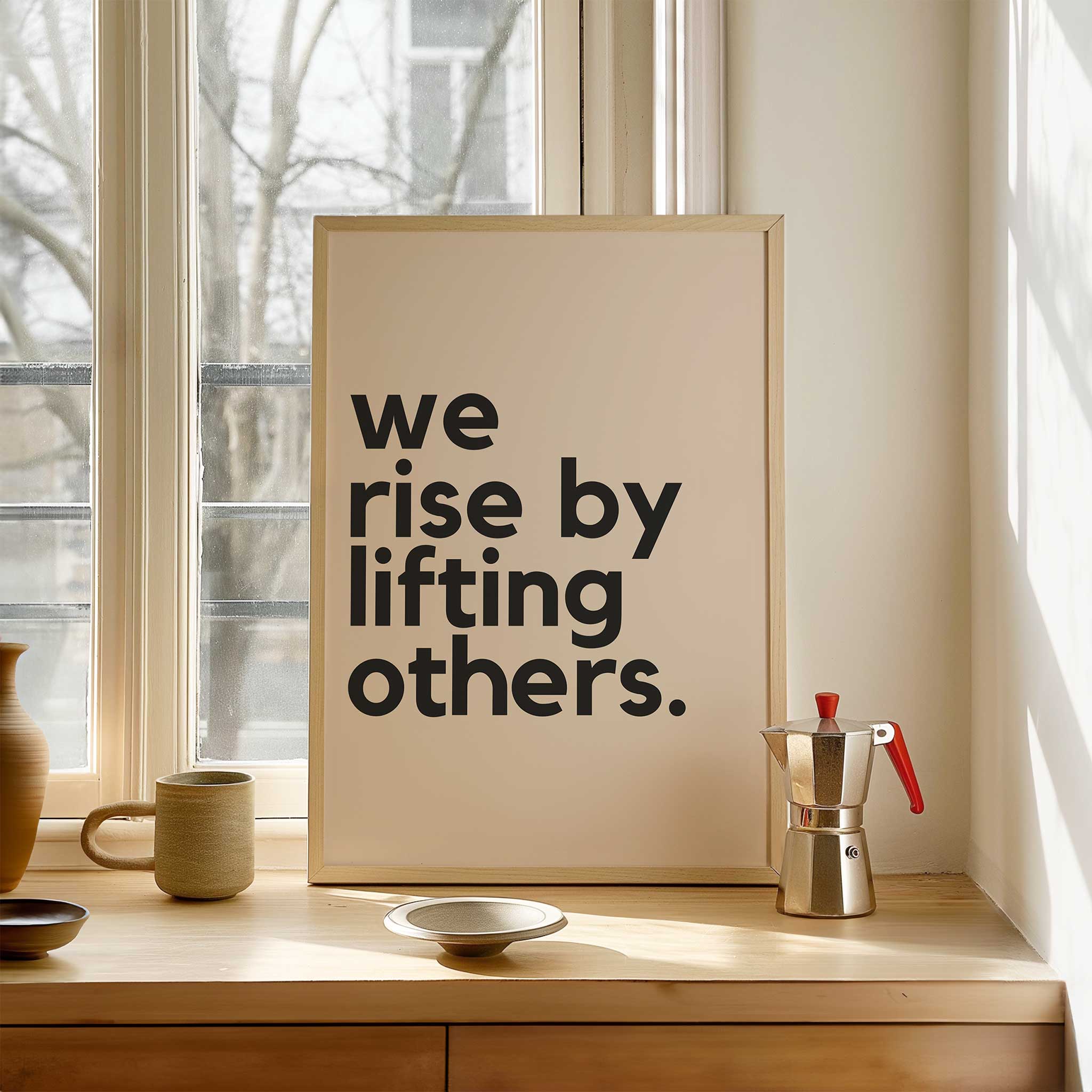 We Rise by Lifting Others' empowering typography, framed wall art print for a kindness aesthetic, titled 'We Rise by Lifting Others'