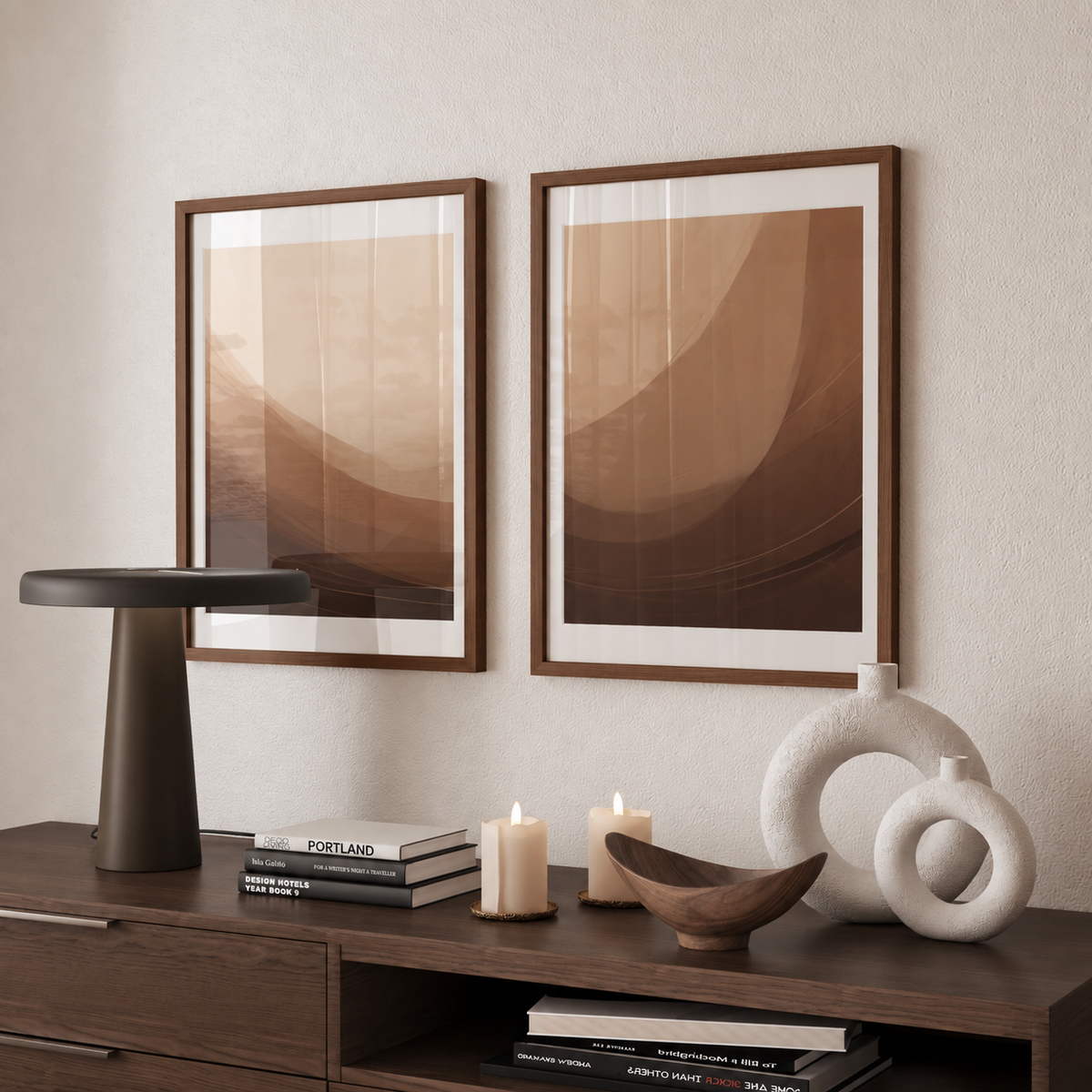 a modern interior design with a wooden dresser, two framed abstract paintings, a black lamp, a white vase, and a wooden bowl on a shelf.